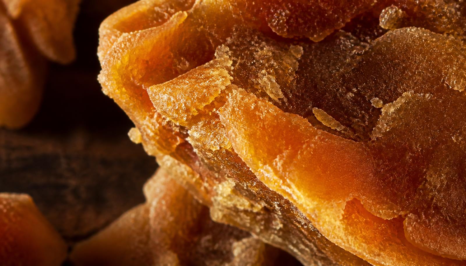 Macro texture of freshly broken golden jaggery